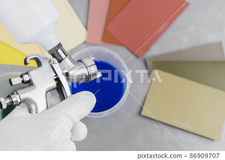 paint spray gun at work at the workplace in the workshop. 86909707