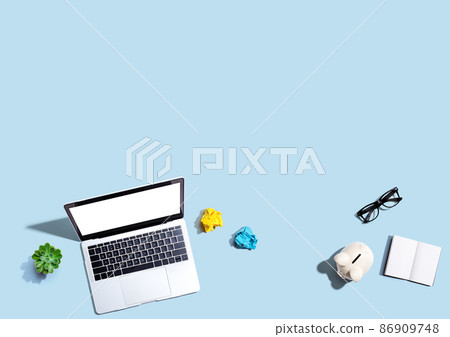 Laptop computer with a piggy bank and office objects Laptop computer with a piggy bank and office objects 86909748