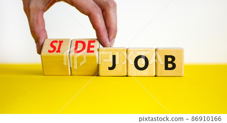 Side job symbol. Businessman turns wooden cubes and changes concept words Job to Side job. Beautiful yellow table white background, copy space. Business side job concept. Side job symbol. Businessman turns wooden cubes and changes concept words Job to Side job. Beautiful yellow table white background, copy space. Business side job concept. 86910166