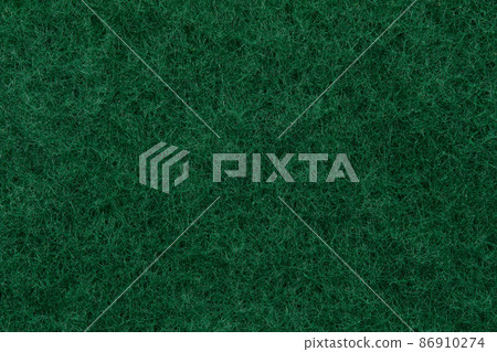 Texture of a abrasive scourer dishwashing sponge. Background of a scrub sponge close up. Texture of a abrasive scourer dishwashing sponge. Background of a scrub sponge close up. 86910274