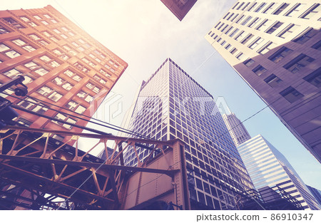 Looking up at Chicago buildings, color toning applied, USA. Looking up at Chicago buildings, color toning applied, USA. 86910347