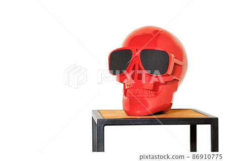 Red colored human skull mockup on coffee table in loft style isolated on white background. Red colored human skull mockup on coffee table in loft style isolated on white background. 86910775