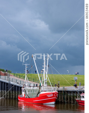 Fishing Boat in Dornumersiel, Lower Saxony, Germany Fishing Boat in Dornumersiel, Lower Saxony, Germany 86913489