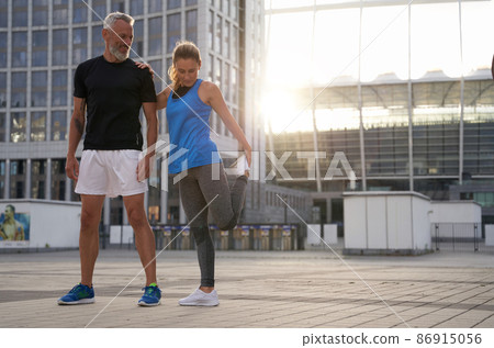 Full length shot of sporty mature couple, man and woman ready for exercising together in the city on a summer day 86915056