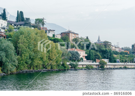Milan, Italy - September 15, 2021: embankment at Como lake with beautiful landscape scenery at Lecco - travel destination in Lombardia 86916806