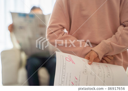 A child hiding his test score A child hiding his test score 86917656