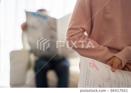 A child hiding his test score A child hiding his test score 86917681