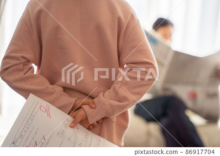 A child hiding his test score A child hiding his test score 86917704