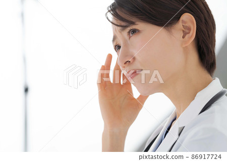 Worried female medical worker Worried female medical worker 86917724