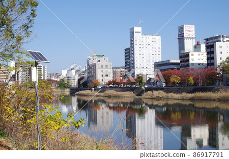 Hiroshima cityscape seen from the Tenma Riverside park Hiroshima cityscape seen from the Tenma Riverside park 86917791
