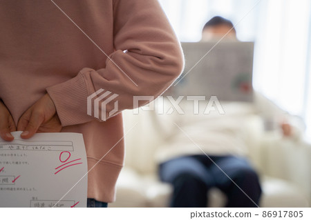 A child hiding his test score A child hiding his test score 86917805