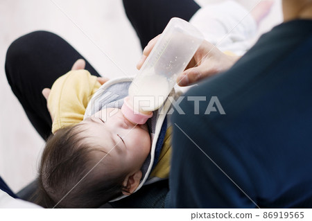 Asian baby drinking milk while sleeping 86919565