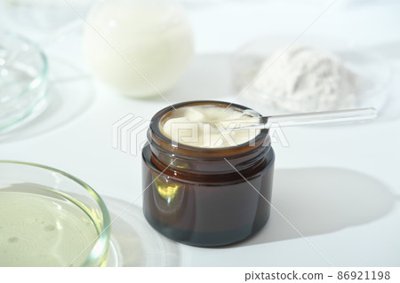 petri dishes with medium and glassware on a laboratory table. fermentation, fermented beauty skin care. container with cream or solution or serum for anti age treatment developed in a lab petri dishes with medium and glassware on a laboratory table. fermentation, fermented beauty skin care. container with cream or solution or serum for anti age treatment developed in a lab 86921198