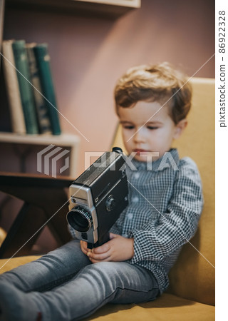A boy in a retro movie camera. A boy in a retro movie camera. 86922328
