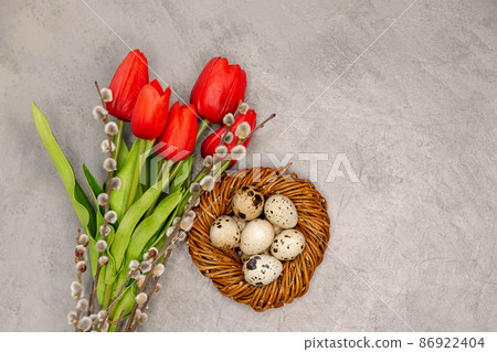 Flowers, eggs in the nest . Easter decoration on the grey background. 86922404