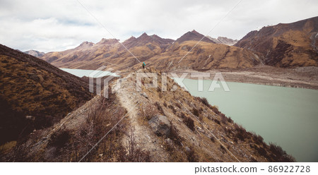 Woman backpacker hiking in winter plateau mountains 86922728