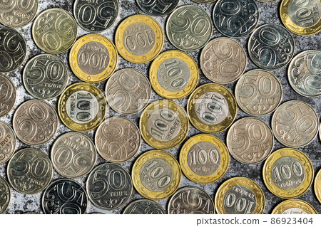 Background from Kazakhstani coins with a face value of 50 and 100 tenge, top view 86923404