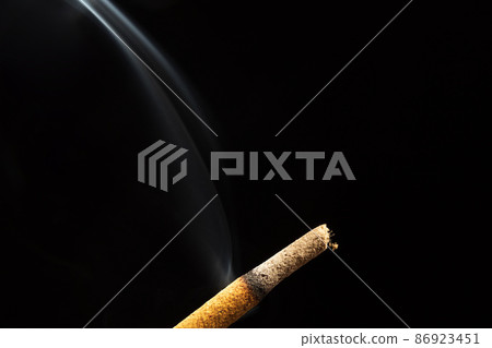 Close up of burning incense stick isolated on a black background Close up of burning incense stick isolated on a black background 86923451