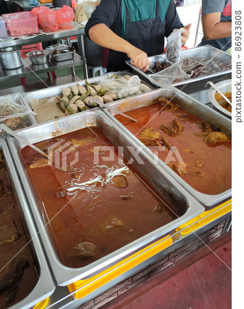 Malaysian traditional Malay cuisine is on display for sale at roadside stalls. Rich in spices and recipes from local ingredients. Customers are free to choose what they like 86923808
