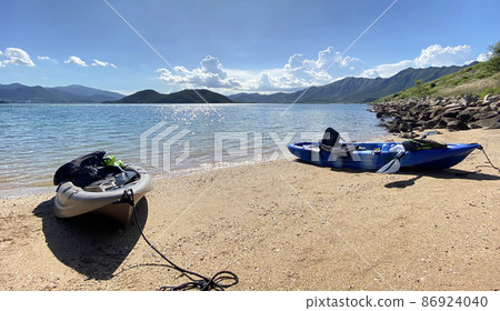 Outdoor kayaking water sport adventure on the beach with beautiful clouds Outdoor kayaking water sport adventure on the beach with beautiful clouds 86924040