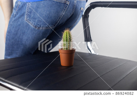 Concept. A man holds a cactus as a symbol of rectal pain. Varicose veins of the lower intestine. Pain in the rectum, hemorrhoids and pain in the excretory system of the body. Proctology Concept. A man holds a cactus as a symbol of rectal pain. Varicose veins of the lower intestine. Pain in the rectum, hemorrhoids and pain in the excretory system of the body. Proctology 86924082