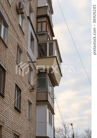 Misunderstood balconies on the wall of the apartments. Different in shape, size, material and construction balconies one above the other. Architecture 86926285