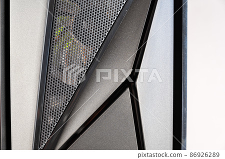 The front of a modern desktop computer. Black system unit in a geometric futuristic design. Digital technology. Close-up. Selective focus The front of a modern desktop computer. Black system unit in a geometric futuristic design. Digital technology. Close-up. Selective focus 86926289