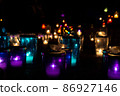 A group of candles of various colors lit up 86927146