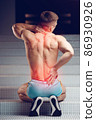 Injured spine. Young handsome muscular athlete having spine pain 86930926
