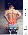 Injured spine. Young handsome muscular athlete having spine pain 86930929