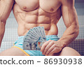 Cash dollars money in the hands of a muscular young man 86930938