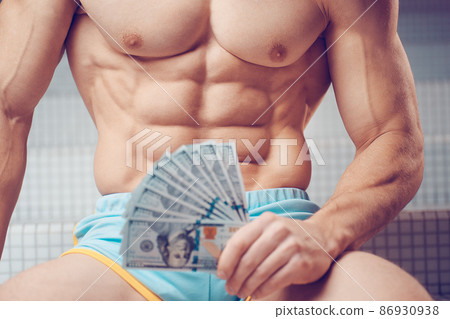 Cash dollars money in the hands of a muscular young man Cash dollars money in the hands of a muscular young man 86930938