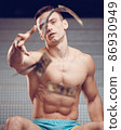 Muscular athletic generous man throws bills money, dollar 86930949