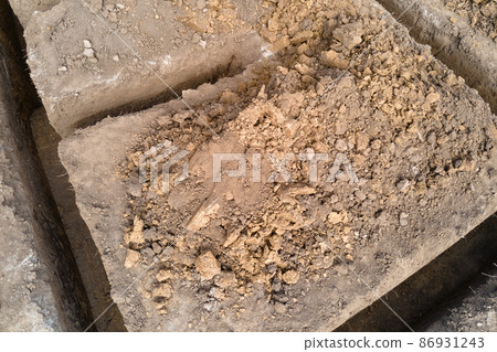 Dug out trench for building works of new house concrete foundation on construction site Dug out trench for building works of new house concrete foundation on construction site 86931243