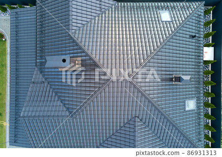 Closeup of house roof top covered with shiny ceramic shingles. 86931313