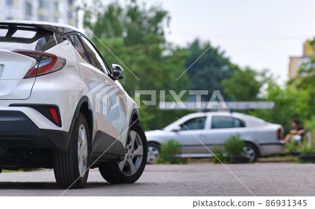 Close up of a car parked on city street side. 86931345