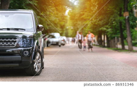 Close up of a car parked illegally against traffic rules on pedestrian city street side. Close up of a car parked illegally against traffic rules on pedestrian city street side. 86931346