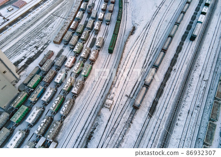 Aerial view of cargo train cars loaded with construction goods at mining factory. Railway transportation of industrial production raw materials Aerial view of cargo train cars loaded with construction goods at mining factory. Railway transportation of industrial production raw materials 86932307
