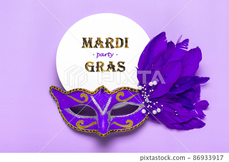 Mardi gras lettering. Congratulation card with mask on white podium on violet background Top view 2022 Mardi Gras Parade Schedule 86933917