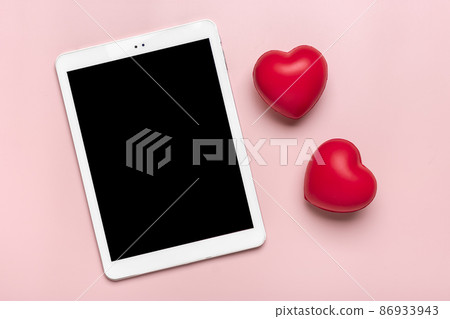 tablet for chooses gifts, makes purchase, two red hearts on pink table Top view Flat lay Holiday shopping list, Happy Valentine's day, party, online shop concept Mock up tablet for chooses gifts, makes purchase, two red hearts on pink table Top view Flat lay Holiday shopping list, Happy Valentine's day, party, online shop concept Mock up 86933943