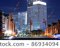 Modern construction crane and red brick warehouse 86934094