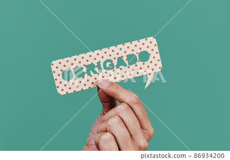 man shows note with text thank you in portuguese 86934200