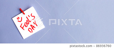 sticker with text fools day hanging on the pin on the veri peri purple background. banner 86936760