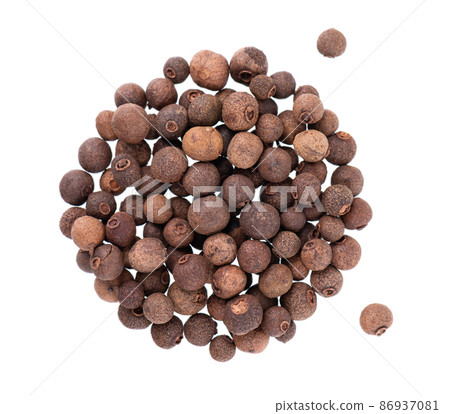 Allspice pile isolated on white background. Jamaican pepper, pimento berry, allspice peppercorns or myrtle pepper. Top view. Allspice pile isolated on white background. Jamaican pepper, pimento berry, allspice peppercorns or myrtle pepper. Top view. 86937081