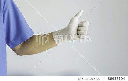 Doctor wearing a blue uniform and rubber gloves and thumbs up. On white background.. Doctor wearing a blue uniform and rubber gloves and thumbs up. On white background.. 86937104