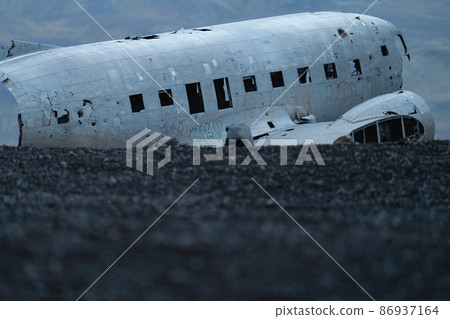 Wreck of and airplane profile over the dark sand Wreck of and airplane profile over the dark sand 86937164
