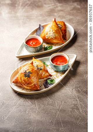 Samosa, samsa meat stuffed pies. Uzbek national dish samosa. Concept of Central Asian, South and East Asian cuisine 86937687