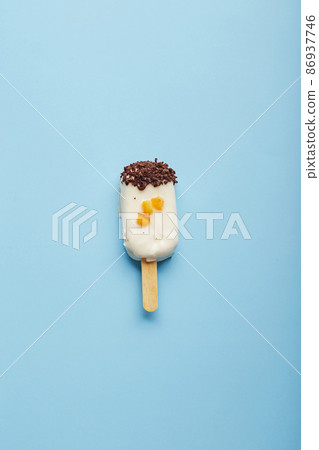 Mousse dessert with fruit flavors in the form of popsicle ice cream on blue background. 86937746