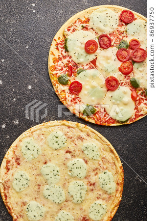 Fast food, Baked frozen pizza Four cheeses and pizza with mozzarella cheese, tomatoes and pesto. Ready to eat Fast food, Baked frozen pizza Four cheeses and pizza with mozzarella cheese, tomatoes and pesto. Ready to eat 86937750