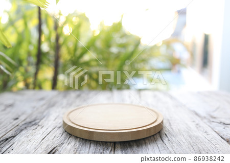 Wooden chopping board on wooden desk surface Wooden chopping board on wooden desk surface 86938242